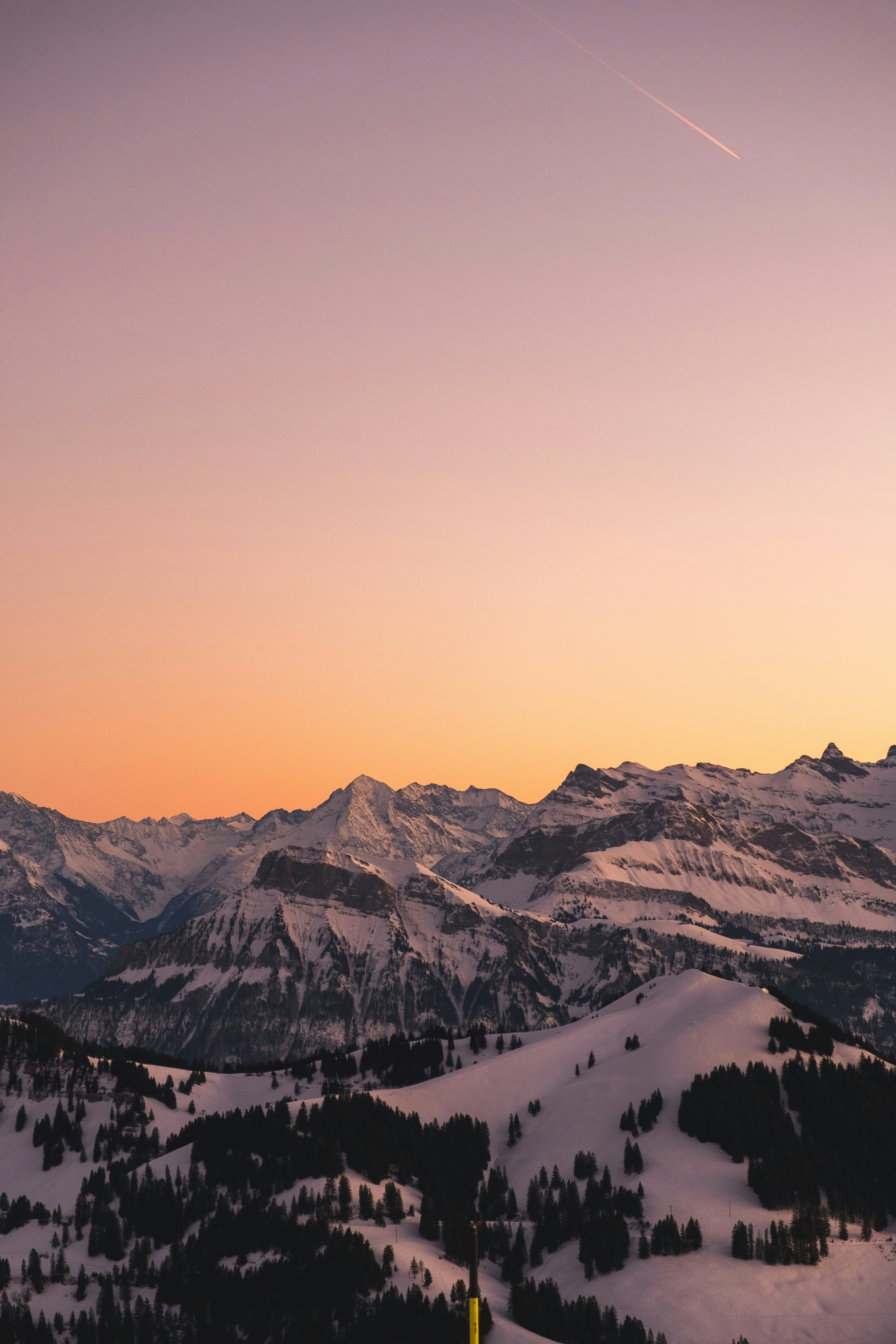 a-person-standing-on-top-of-a-snow-covered-slope