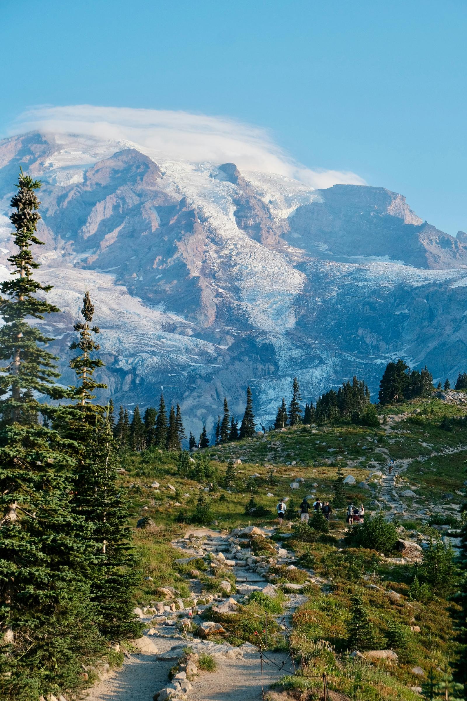 snow-capped-mountain-peak-with-hiking-trail-and-trees